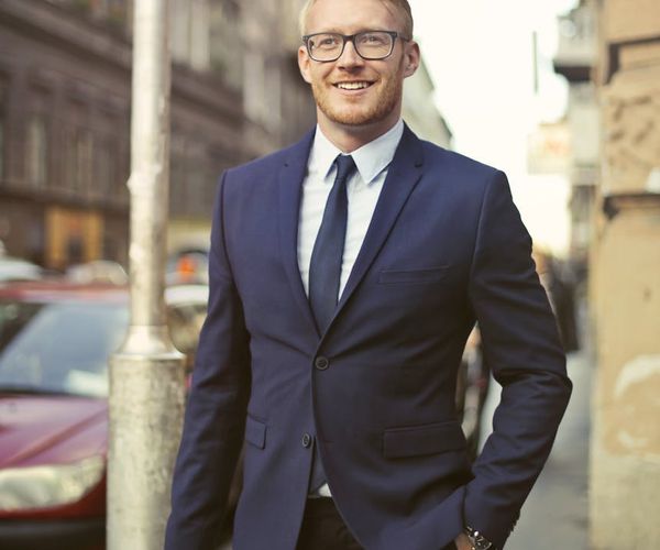 Man stretching at his office desk, integrating movement into his day.